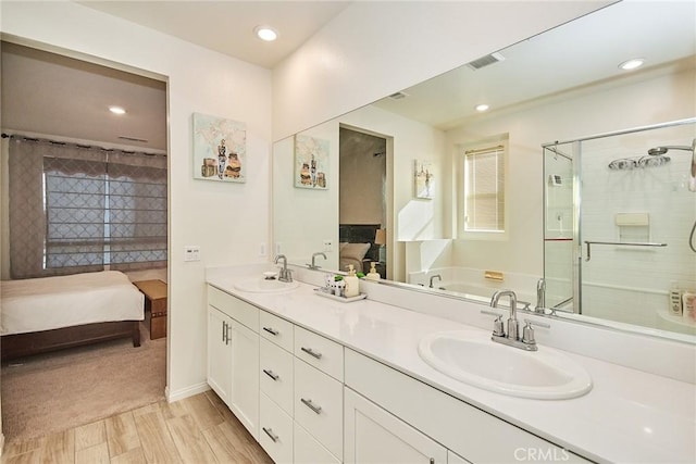 bathroom featuring vanity, separate shower and tub, and wood-type flooring