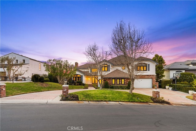 view of front of property with a lawn and a garage