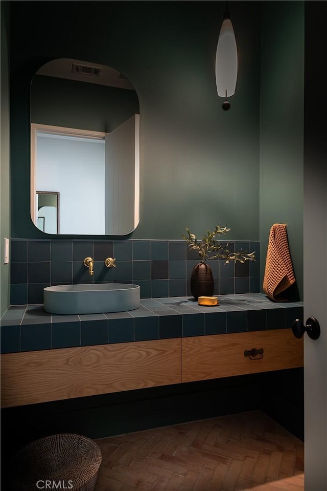 bathroom with parquet floors and vanity