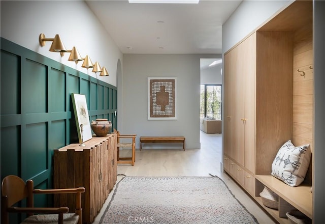 mudroom with light hardwood / wood-style floors