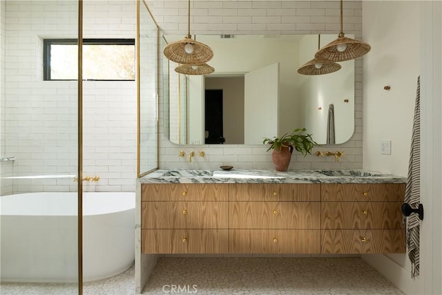 bathroom with tasteful backsplash, vanity, and a bathtub