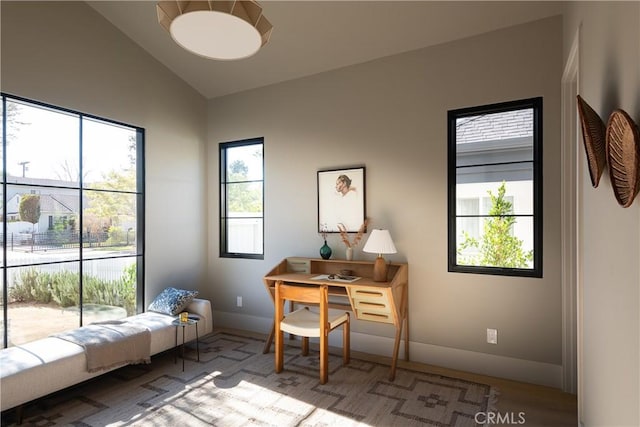 home office with a wealth of natural light and lofted ceiling