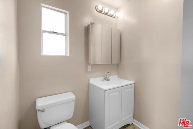 bathroom featuring toilet and vanity