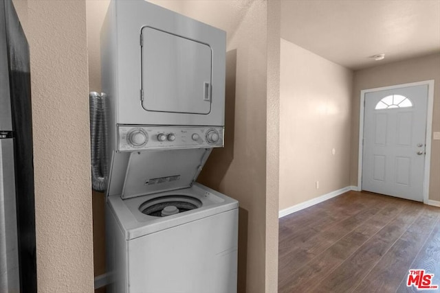 washroom with stacked washing maching and dryer and dark hardwood / wood-style flooring