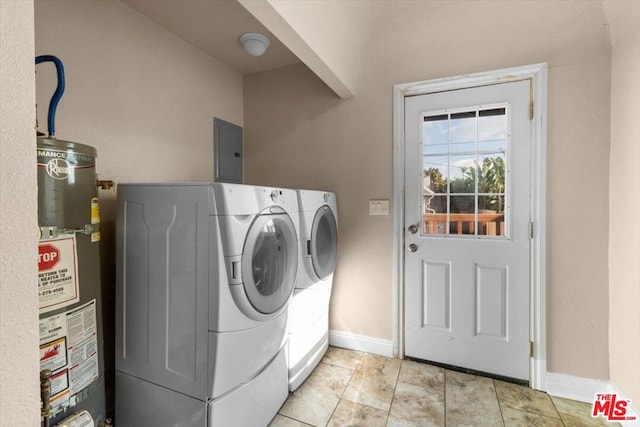 laundry area featuring water heater, light tile patterned floors, electric panel, and washer and clothes dryer