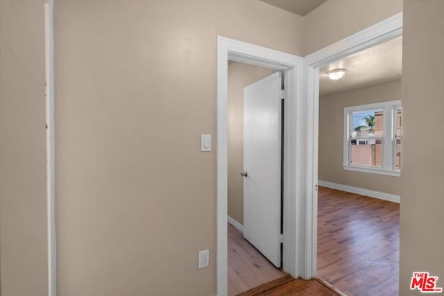 corridor with light hardwood / wood-style floors