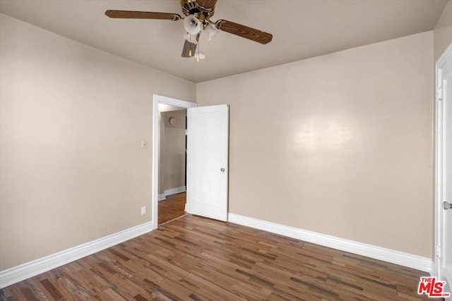 spare room featuring ceiling fan and dark hardwood / wood-style floors