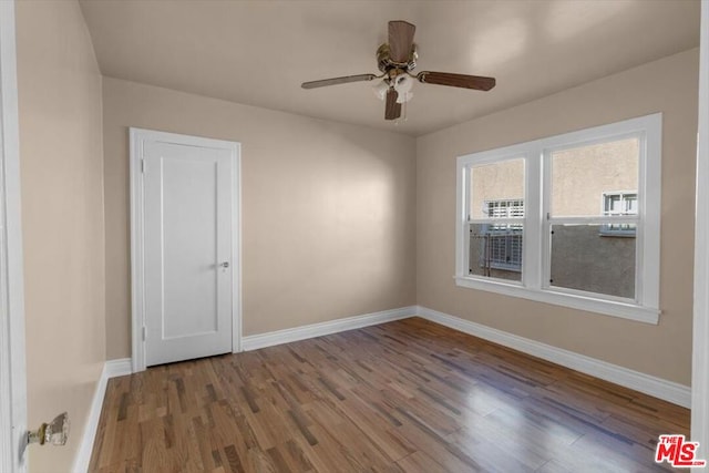 empty room featuring ceiling fan and hardwood / wood-style floors