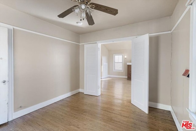 empty room featuring ceiling fan and hardwood / wood-style floors