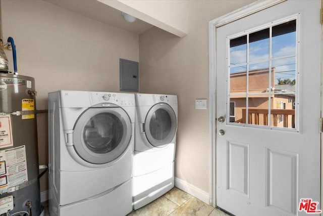 laundry area with light tile patterned floors, electric panel, water heater, and washing machine and clothes dryer