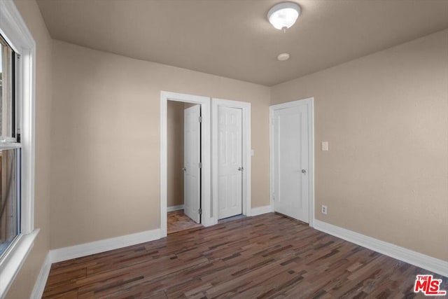 unfurnished bedroom featuring dark hardwood / wood-style floors