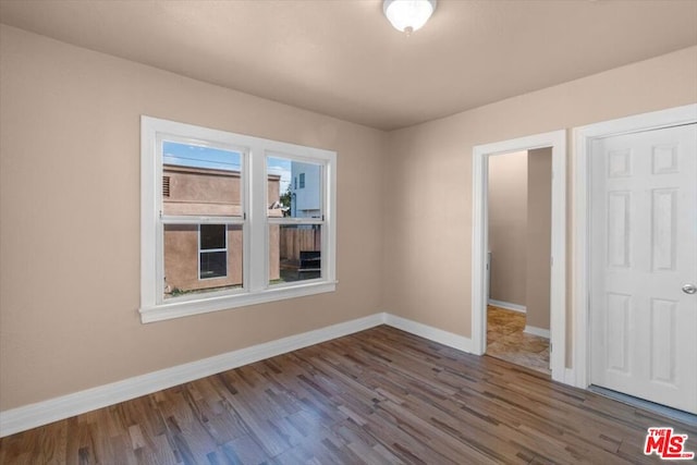 unfurnished bedroom featuring dark wood-type flooring