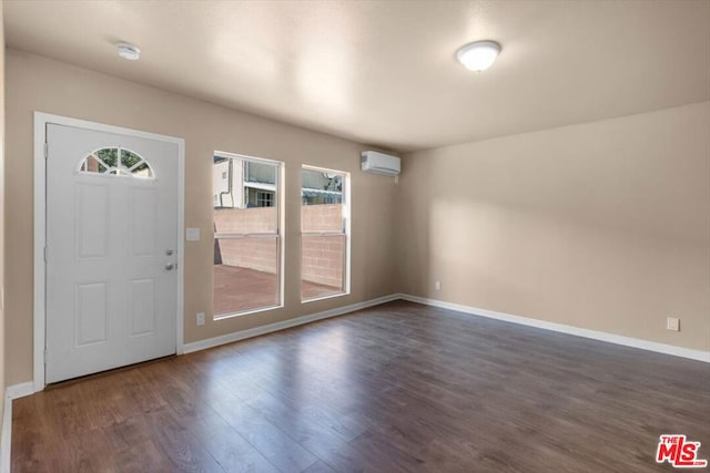 entrance foyer with dark hardwood / wood-style flooring and a wall mounted air conditioner