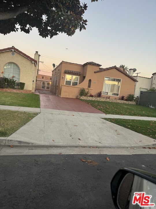 mediterranean / spanish-style home featuring a lawn