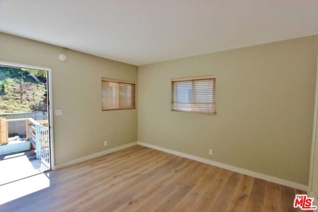 unfurnished room with light hardwood / wood-style flooring