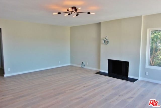 unfurnished living room with light hardwood / wood-style floors