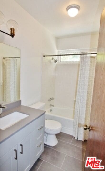 full bathroom with toilet, vanity, tile patterned floors, and shower / bath combination with curtain