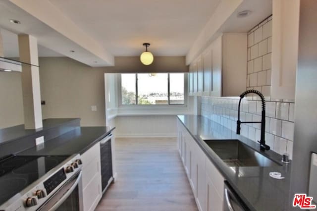 kitchen featuring white cabinets, sink, stainless steel appliances, and light hardwood / wood-style floors