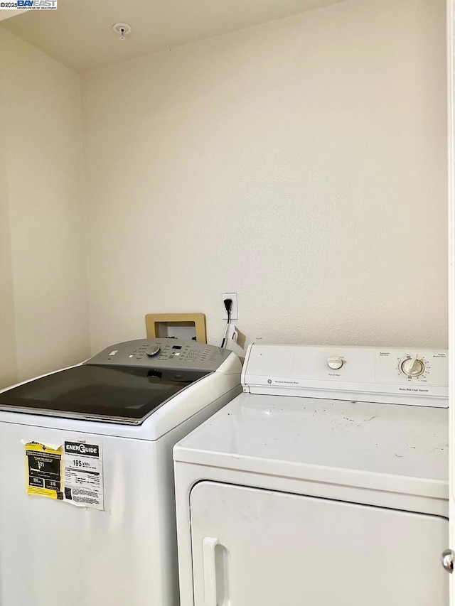 clothes washing area featuring washer and clothes dryer