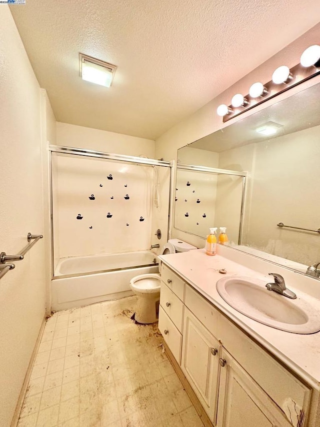 full bathroom featuring vanity, toilet, a textured ceiling, and shower / bathing tub combination