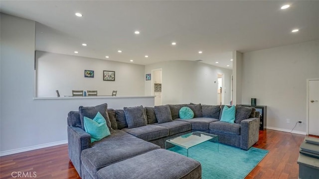 living room with baseboards, wood finished floors, and recessed lighting