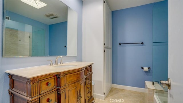 bathroom featuring baseboards, visible vents, vanity, and tile patterned floors