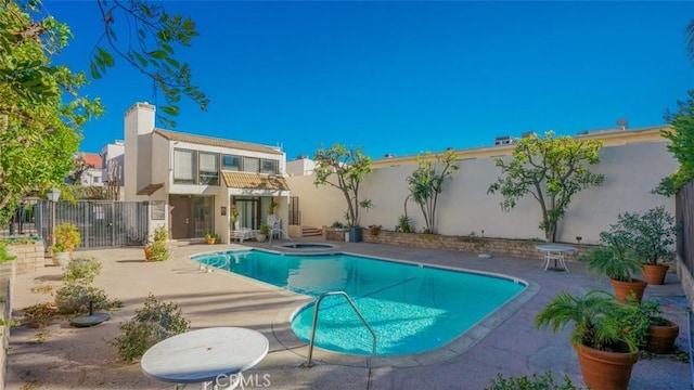 view of swimming pool featuring an in ground hot tub and a patio