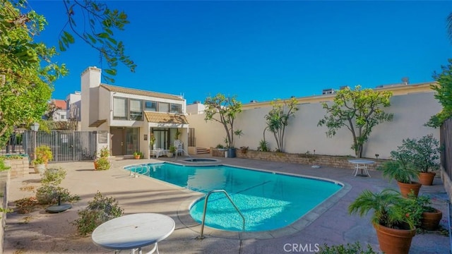 view of swimming pool with a fenced in pool, a patio area, a fenced backyard, and an in ground hot tub