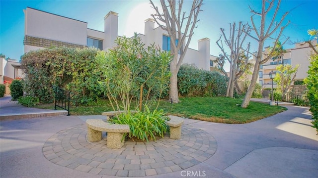 view of home's community with a patio area and a yard