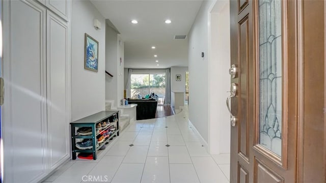 foyer with tile patterned flooring, visible vents, baseboards, and recessed lighting