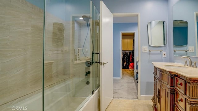 bathroom with tile patterned flooring, vanity, and combined bath / shower with glass door