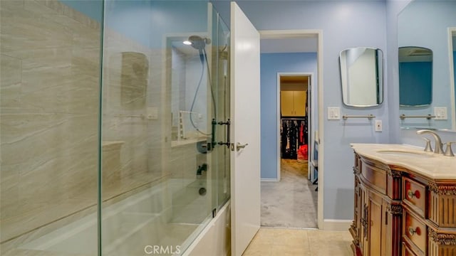 full bath featuring tile patterned flooring, enclosed tub / shower combo, and vanity