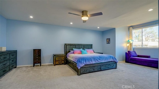 bedroom with ceiling fan and light carpet