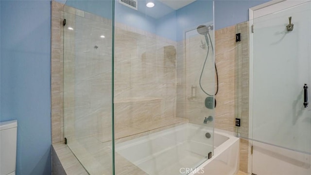 bathroom featuring visible vents and shower / bath combination with glass door