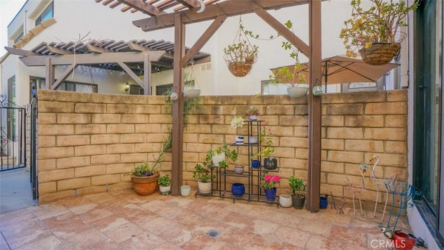 view of patio / terrace featuring fence, a gate, and a pergola