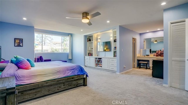 carpeted bedroom featuring ensuite bath and ceiling fan