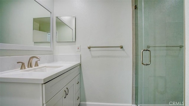 bathroom with walk in shower and vanity