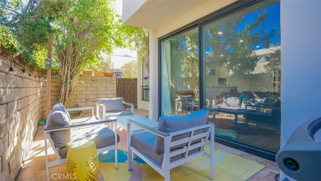 view of patio featuring fence and outdoor lounge area