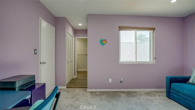 living area with light colored carpet