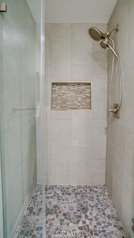 bathroom featuring a shower with door