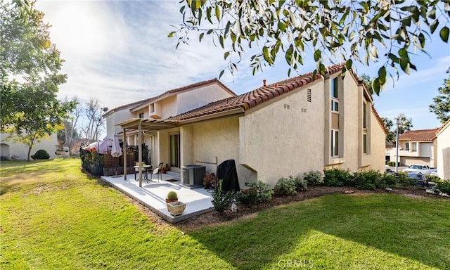 back of property featuring central AC, a patio area, and a lawn