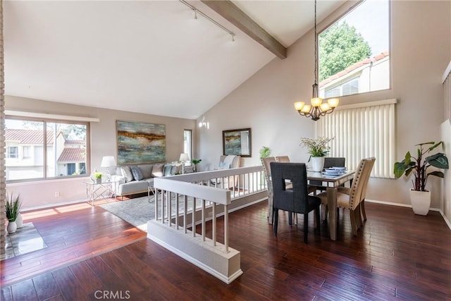 dining area with beamed ceiling, dark hardwood / wood-style flooring, rail lighting, and a chandelier