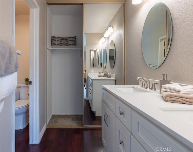 bathroom featuring vanity, hardwood / wood-style flooring, and toilet