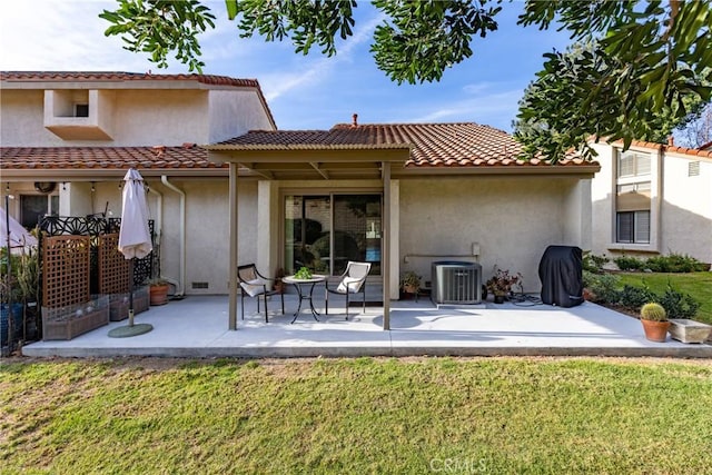 back of house with cooling unit, a lawn, and a patio