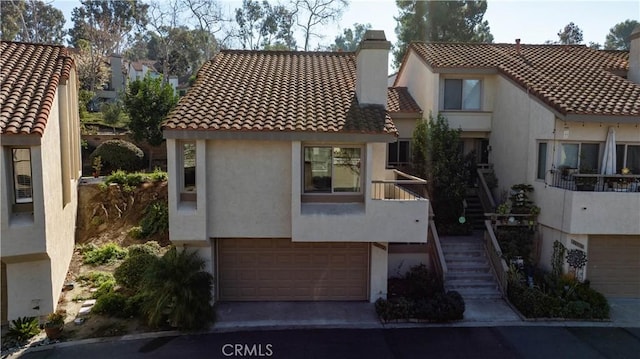 mediterranean / spanish home with a balcony and a garage