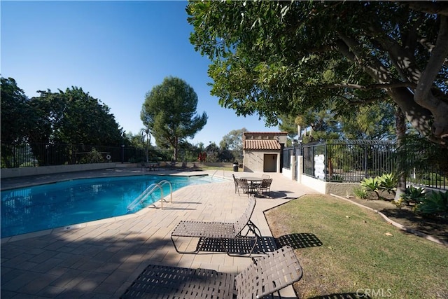 view of pool featuring a patio area and a lawn