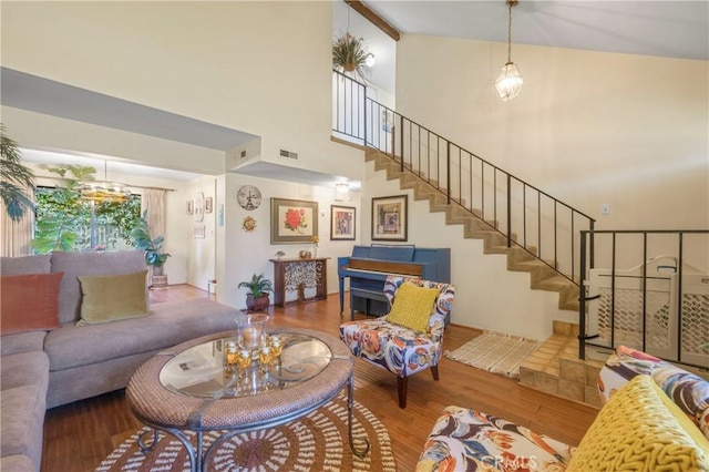 living room featuring wood-type flooring and high vaulted ceiling