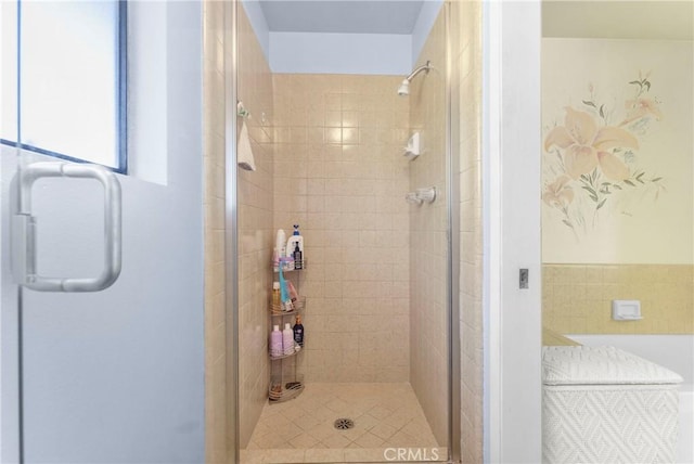 bathroom with a shower with door