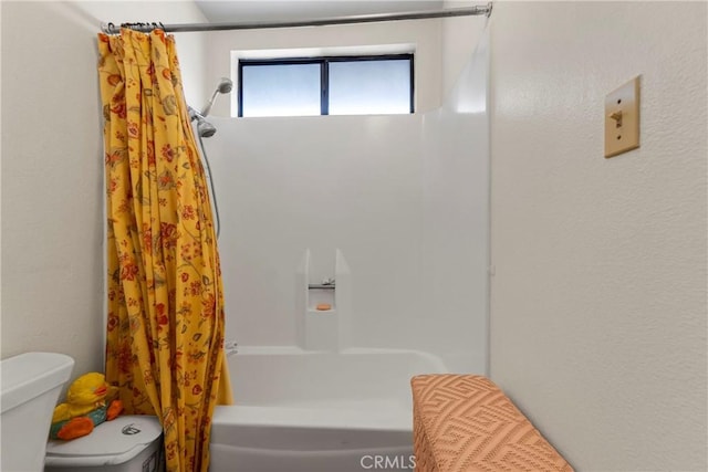 bathroom with toilet and shower / bathtub combination with curtain