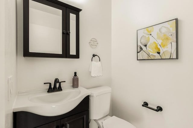 bathroom featuring vanity and toilet